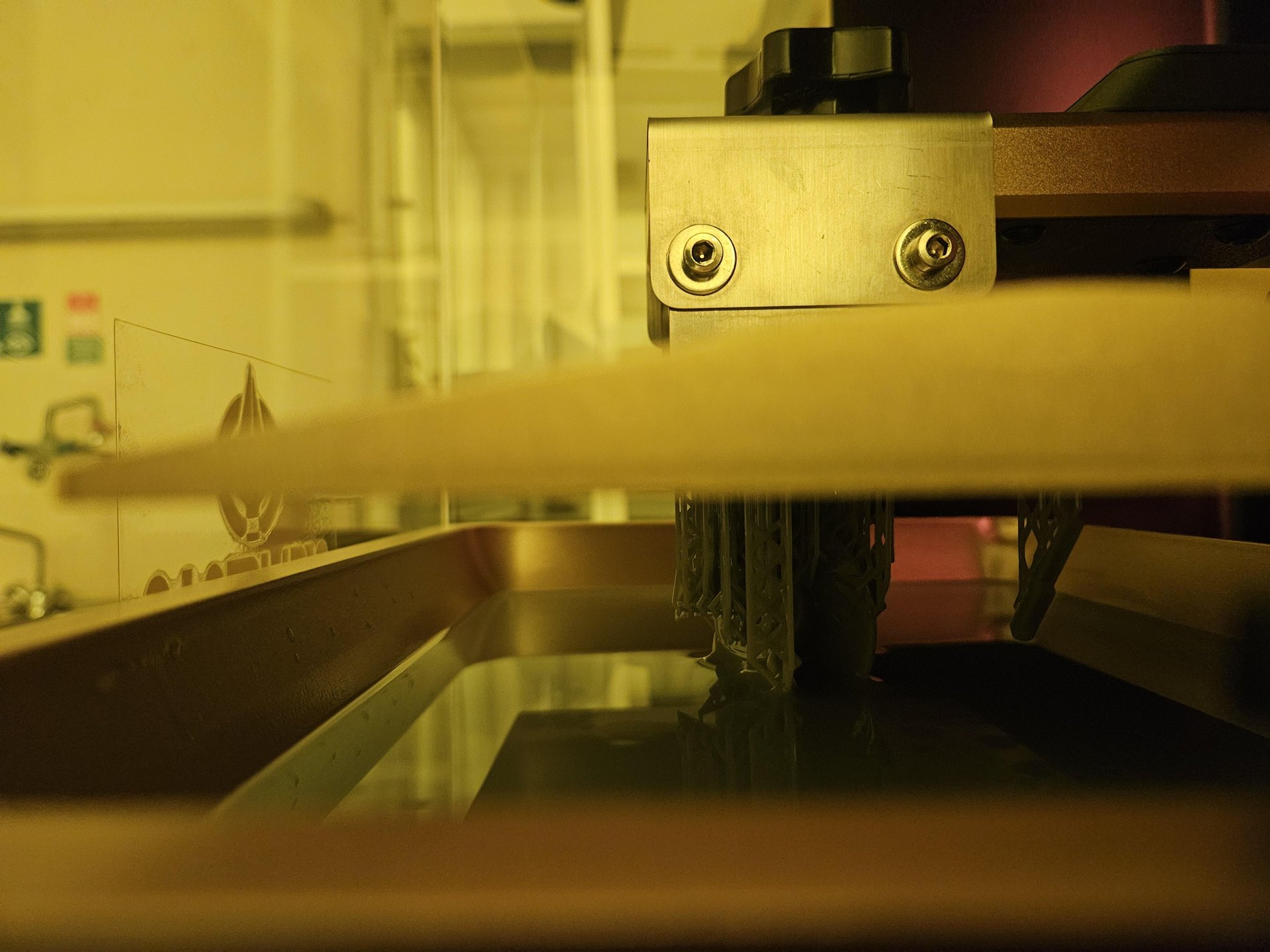 A resin print being lifted from the Athena I vat